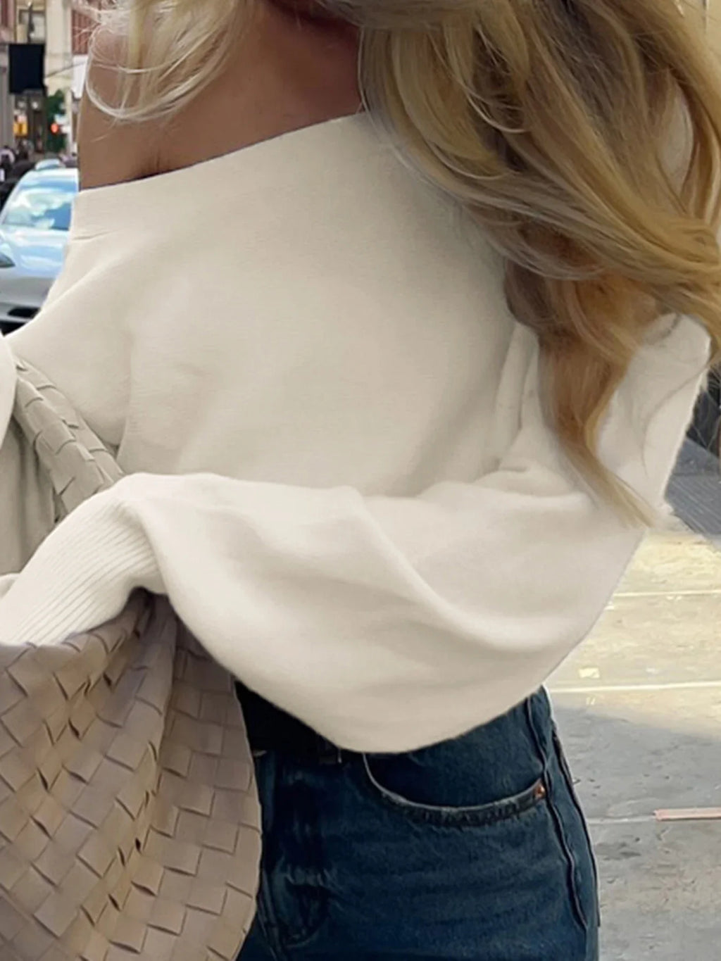 Off-shoulder sweater styled
